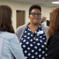 Ayana Weekley chats with two faculty members